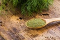 Fresh and dried dill on wooden cutting board