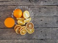 Fresh and dried orange fruit with smoothie juice on a wooden rustic background. Copy space Royalty Free Stock Photo