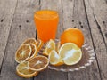 Fresh and dried orange fruit with smoothie juice on a wooden rustic background. Copy space Royalty Free Stock Photo