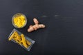 Fresh and dried turmeric roots and powder on black background. Top view, copy space Royalty Free Stock Photo