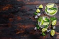 Fresh drink lemonade mojito. Mojitos with mint leaves, lime and ice. Black wooden background. Top view. Copy space Royalty Free Stock Photo