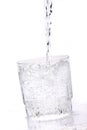 Fresh drinking water pouring into the glass on a white background Royalty Free Stock Photo