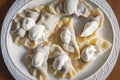 Fresh dumplings with cherry filling and cream