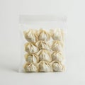 Fresh dumplings in clear plastic packaging on white background Royalty Free Stock Photo