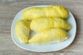 Fresh durian fruit placed on a white plate. Durian the king of fruits The yellow color is on the white plate. Ripe durian tropical Royalty Free Stock Photo