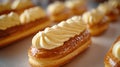 Fresh eclairs topped with cream on a baking sheet. Royalty Free Stock Photo