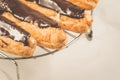 Fresh eclairs on a white marble background/fresh eclairs on a white marble background. Selective focus Royalty Free Stock Photo