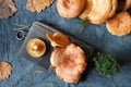 Fresh edible Lactarius deliciosus mushrooms on a wooden chopping board. Seasonal cuisine. Royalty Free Stock Photo