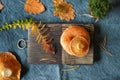 Fresh edible Lactarius deliciosus mushrooms on a wooden chopping board. Seasonal cuisine. Orange-red grass, moss and Royalty Free Stock Photo