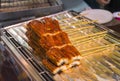 Fresh eel parts on skewers, ready for grill - streetfood in Japan