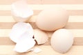 Fresh egg and cracked eggshell on wooden background Royalty Free Stock Photo