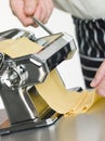 Fresh Egg Pasta being rolled in a Pasta Machine Royalty Free Stock Photo