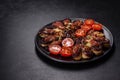 Fresh eggplant baked with minced meat, spices and herbs on a black plate Royalty Free Stock Photo