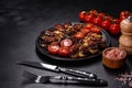 Fresh eggplant baked with minced meat, spices and herbs on a black plate Royalty Free Stock Photo