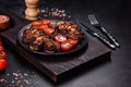 Fresh eggplant baked with minced meat, spices and herbs on a black plate Royalty Free Stock Photo