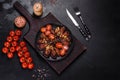 Fresh eggplant baked with minced meat, spices and herbs on a black plate Royalty Free Stock Photo