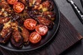 Fresh eggplant baked with minced meat, spices and herbs on a black plate Royalty Free Stock Photo