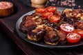 Fresh eggplant baked with minced meat, spices and herbs on a black plate Royalty Free Stock Photo