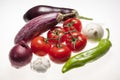 Fresh eggplants, tomatoes, green pepper, onion and garlic over white background Royalty Free Stock Photo