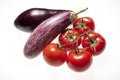 Fresh eggplants and tomatoes over white background Royalty Free Stock Photo