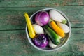 Fresh eggplants and zucchini in basket over wooden green background. Flat lay. Healthy food or diet. Royalty Free Stock Photo