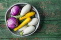 Fresh eggplants and zucchini in basket over wooden green background. Flat lay. Healthy food or diet. Royalty Free Stock Photo