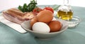 fresh eggs, bacon, vegetables and oil. ingredients for making scrambled eggs. Royalty Free Stock Photo