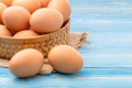 Fresh eggs in bamboo basket on blue wooden background. for food concept Royalty Free Stock Photo