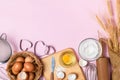 Fresh eggs and cake flour  with kitchen utensils for pastries on pink background Royalty Free Stock Photo