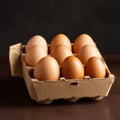 Fresh eggs in carton. Eggs in box container on a wooden table Royalty Free Stock Photo