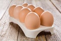 Fresh eggs in an egg tray on a wooden table Royalty Free Stock Photo