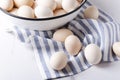 Uncooked eggs just collected on the farm.Lot of eggs in the boel and on the napkin.Kitchen table and eggs on it Royalty Free Stock Photo