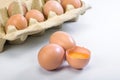 Fresh eggs on a white background. One egg is broken Royalty Free Stock Photo