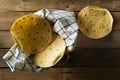 Fresh, empty wheat tortilla flat lay top view on dishcloth on rustic wooden table