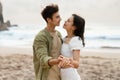 Fresh engaged young couple dancing and enjoying romantic engagement day on the beach on coastline, focus on hands Royalty Free Stock Photo