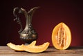 Fresh excised melon and carafe of metal Royalty Free Stock Photo