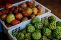 Fresh Exotic Fruits On Traditional Asian Market. Red and green sugar apples in the market. Royalty Free Stock Photo