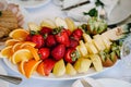 Fresh, exotic, organic fruits, light snacks in a plate on a buffet table. Assorted mini delicacies and snacks, restaurant food at Royalty Free Stock Photo