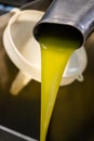 Fresh extra virgin olive oil pouring into tank at a cold-press factory Royalty Free Stock Photo