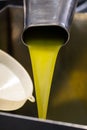 Fresh extra virgin olive oil pouring into tank at a cold-press factory Royalty Free Stock Photo