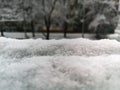 Fresh fallen white snow laying on windowsill behind window