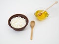 Healthy nutritious breakfast of soft natural cottage cheese and flower honey in earthenware dishes on a white background Royalty Free Stock Photo