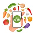 Fresh Farm grocery market. Food service online order and Delivery. Human hand holding a mobile smartphone with natural vegetables