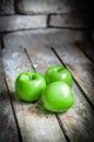 Fresh farm raised apples on rustic wooden background