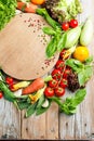 Fresh farm vegetables and herbs on rustic background. Royalty Free Stock Photo