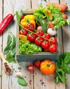 Fresh farm vegetables and herbs on rustic background. Royalty Free Stock Photo