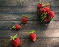 Fresh farmerÃ¢â¬â¢s organic strawberries in tiny metal vintage basket on wooden background top view Royalty Free Stock Photo
