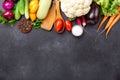 Fresh farmers garden vegetables and kitchen utensils on stone background. Harvest time. Top view Royalty Free Stock Photo