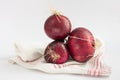 Fresh from the Farmers market red onions Allium Cepa on a kitchen towel