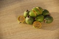 Fresh feijoa fruit on a wooden table in daylight